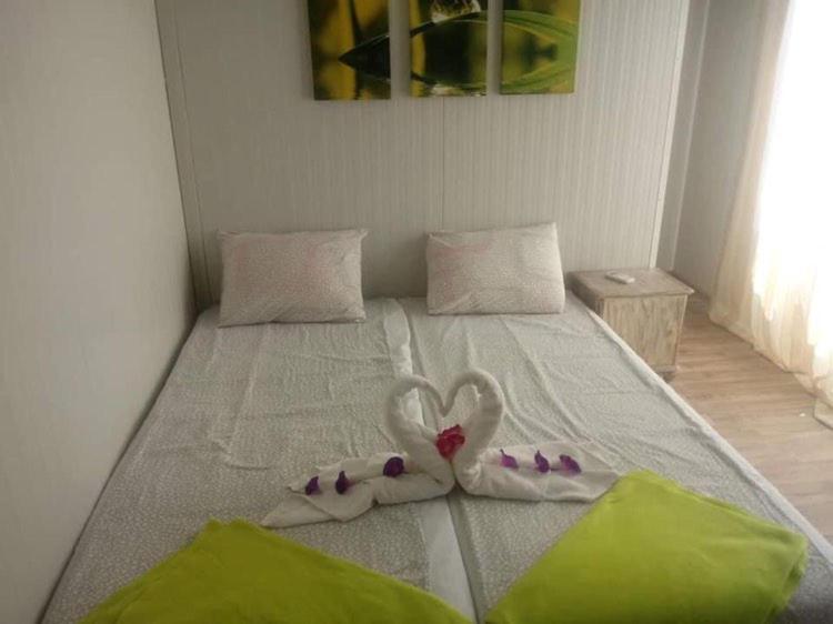 a bed with two towels in the shape of hearts at Къща за гости Симона яз.Тича in Sushina