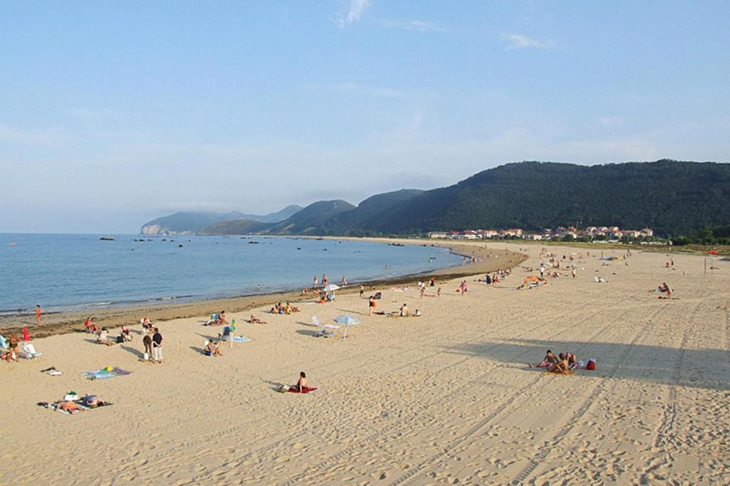 a large group of people on a beach at Residencial Cilla - 6022 in Noja
