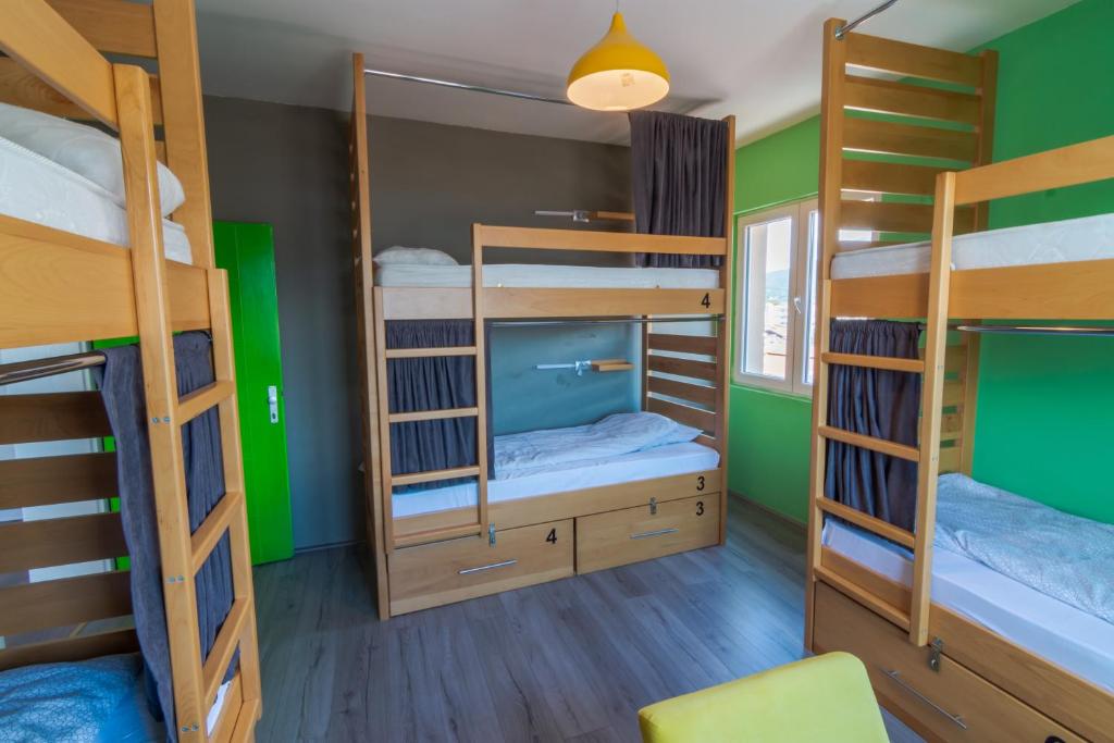 a room with four bunk beds and a mirror at Old Town Hostel Ohrid in Ohrid