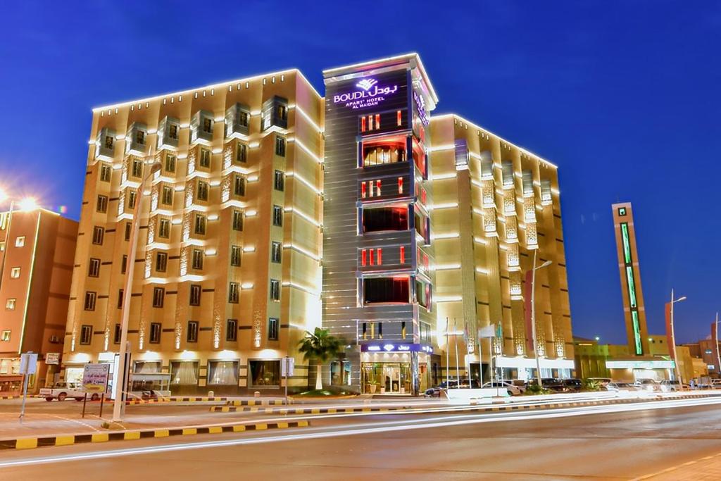 a large building on a city street at night at Boudl Al Maidan in Hafr Al Baten