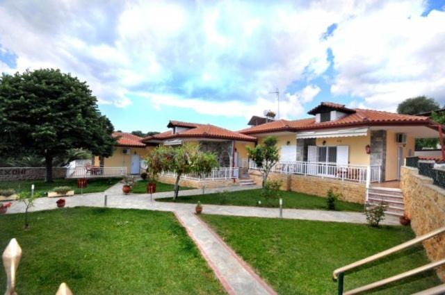 a large house with a yard with a yard sidx sidx sidx at EXOHI STUDIOS in Sarti