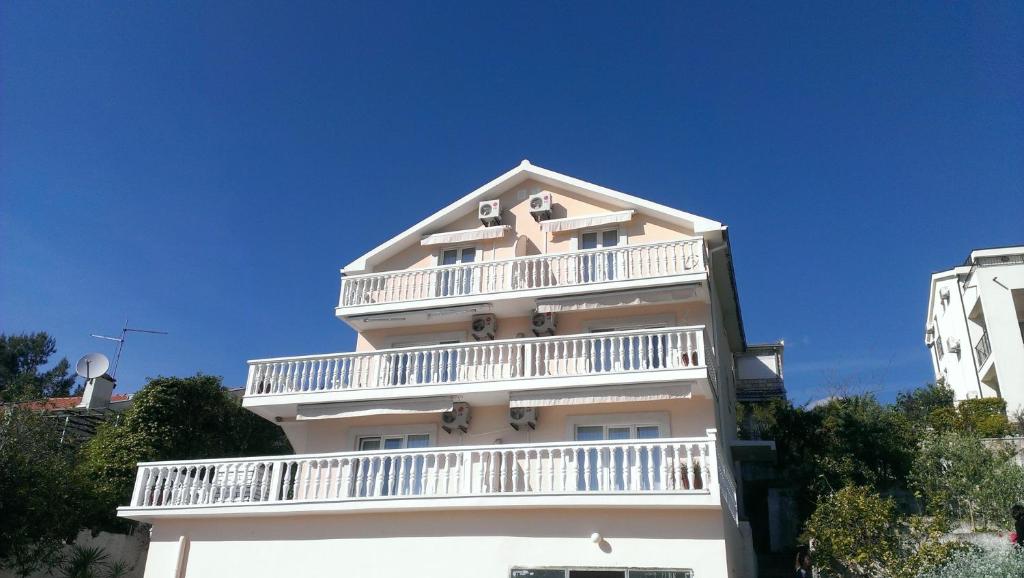 a white building with a balcony on top of it at Apartments Sofija in Tivat