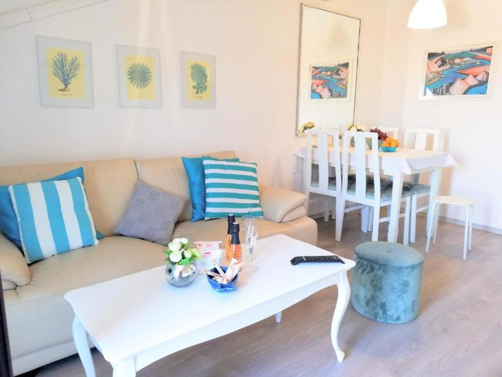 a living room with a couch and a table at Deep Blue Apartment in Poreč