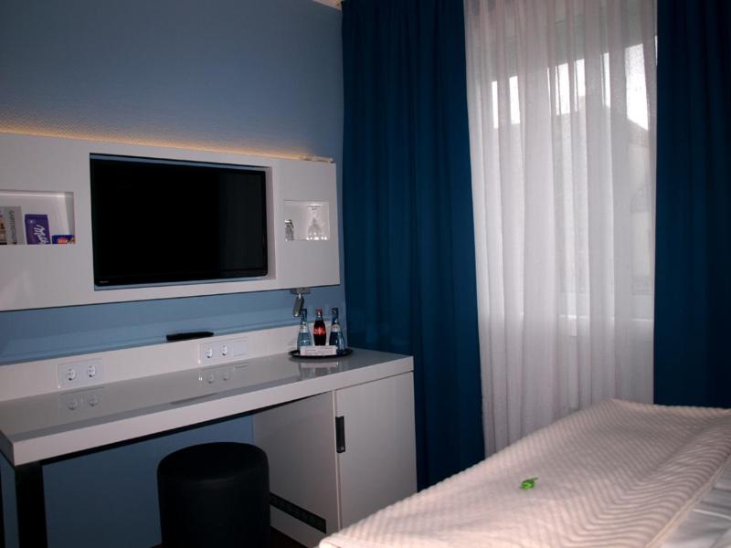 Postel nebo postele na pokoji v ubytování Gartenstadt Hotel