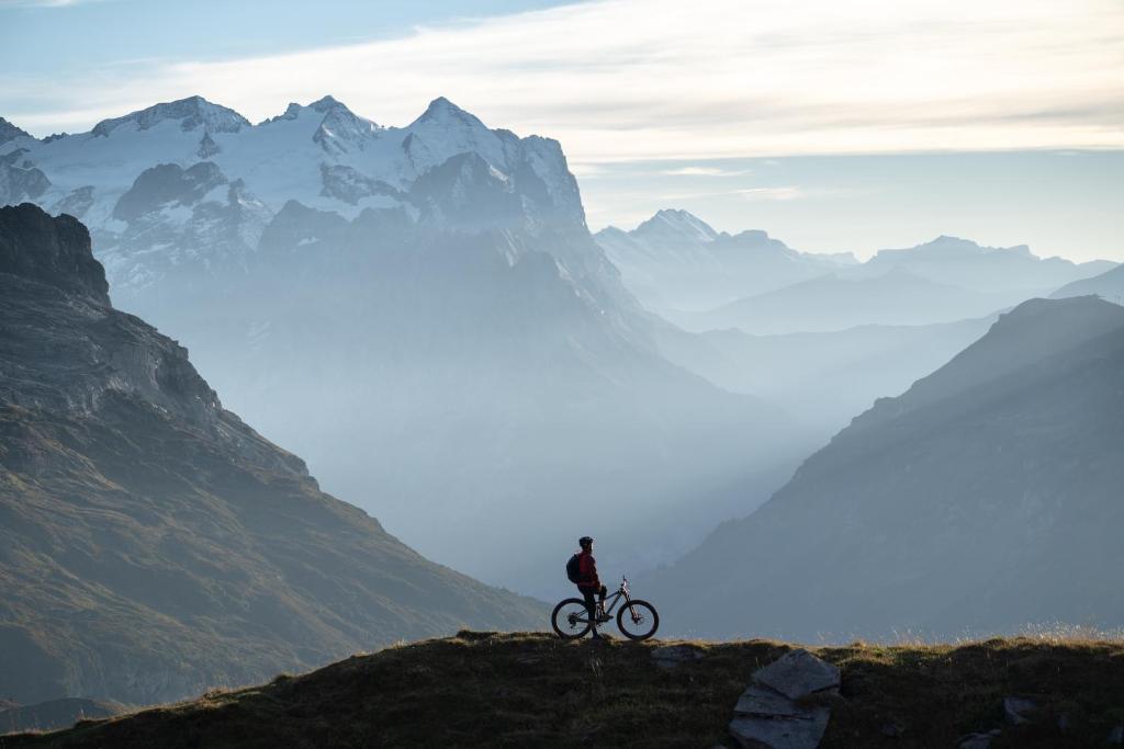 a person riding a bike on top of a mountain at Hotel Central in Engelberg