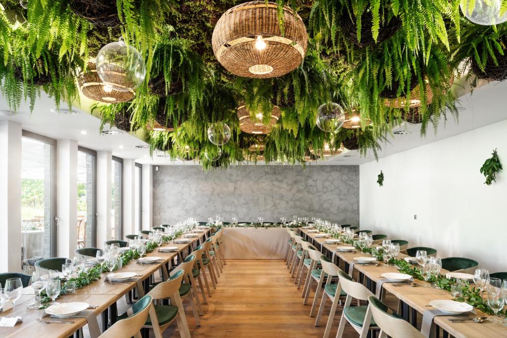 a long banquet hall with long tables and chairs at HERBARIUM boutique hotel in Olomouc