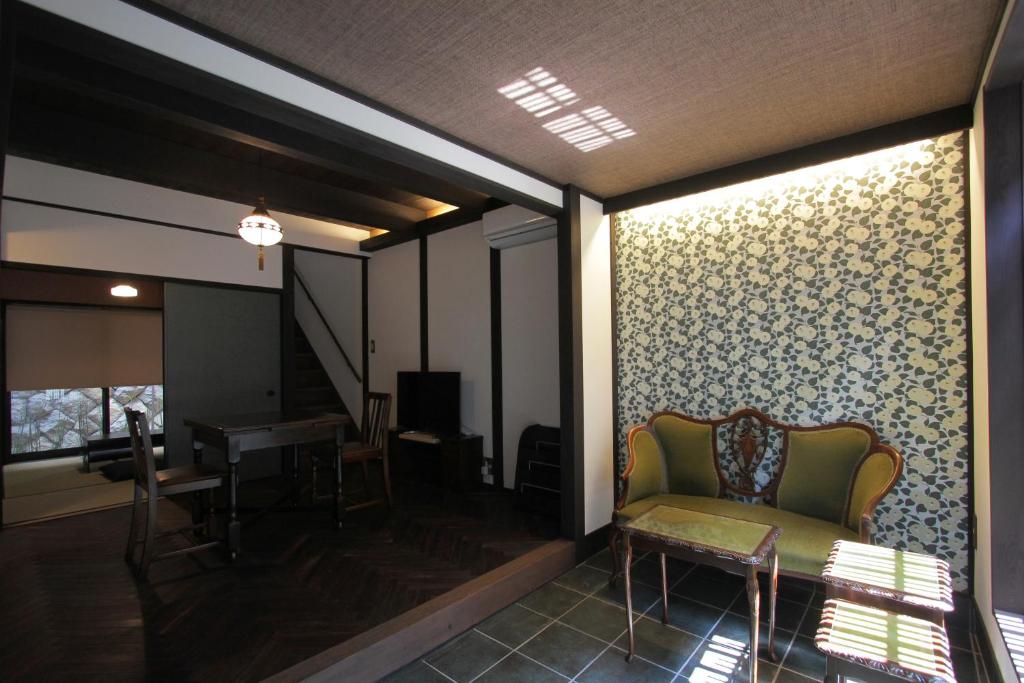a living room with a chair and a table at Kiyomizu Birodo-an in Kyoto