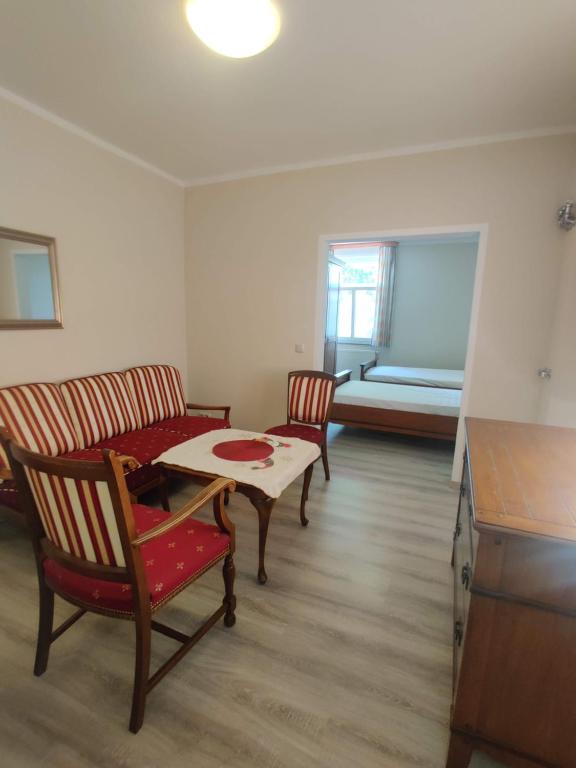 ein Wohnzimmer mit einem Tisch, Stühlen und einem Sofa in der Unterkunft Hotel LG Wolfsburg in Wolfsburg