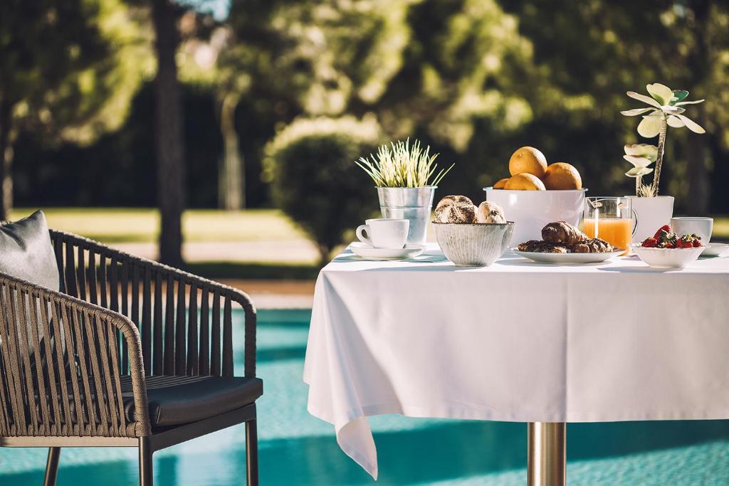 a table with a plate of food on it at Las Gaviotas Suites Hotel & Spa in Playa de Muro