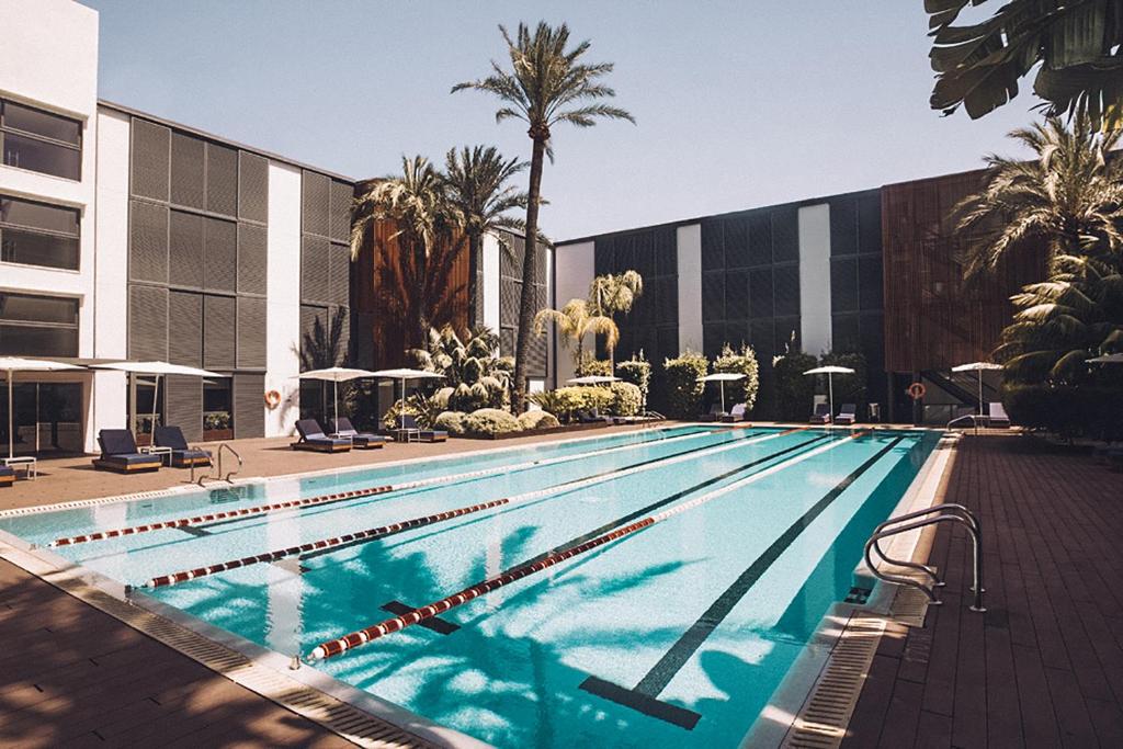 a large swimming pool in front of a building at Las Gaviotas Suites Hotel & Spa in Playa de Muro
