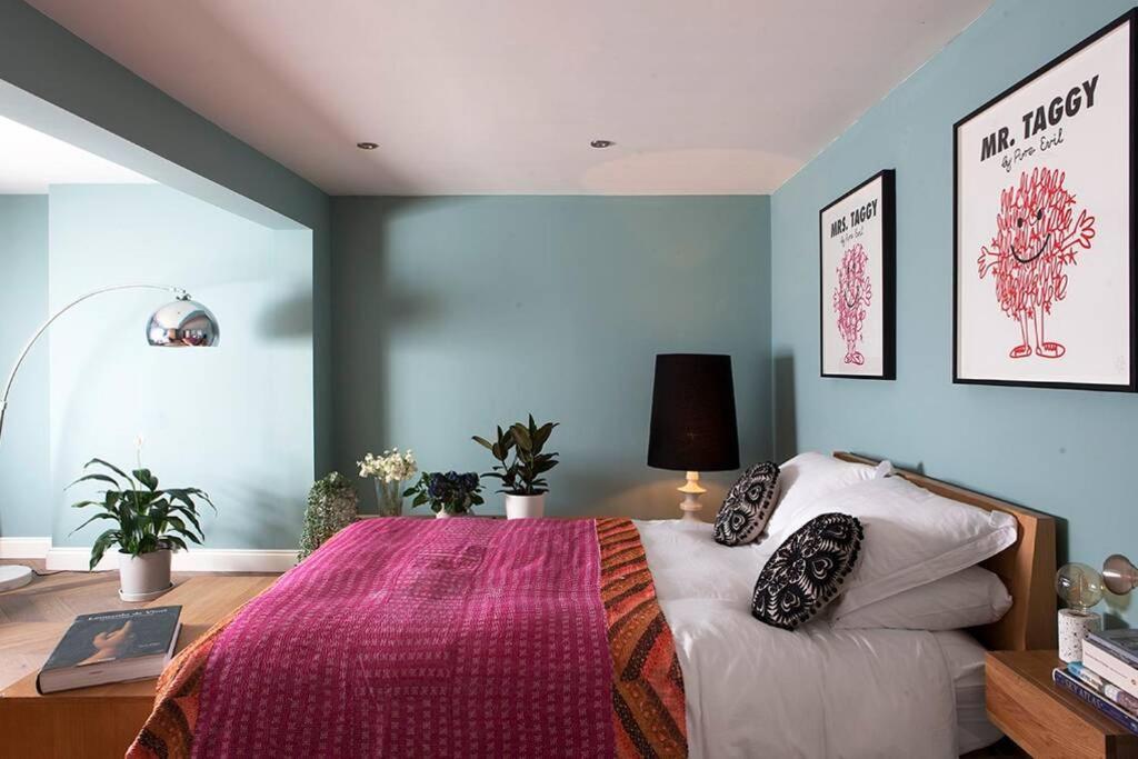 - une chambre avec un grand lit et une couverture rose dans l'établissement Central Hastings, Stylish-Luxe, Seaside Apartment., à Hastings