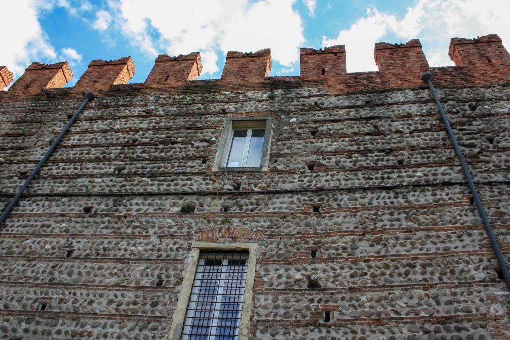 a tall brick building with a window on it at Antiche Mura - Italian Homing in Verona