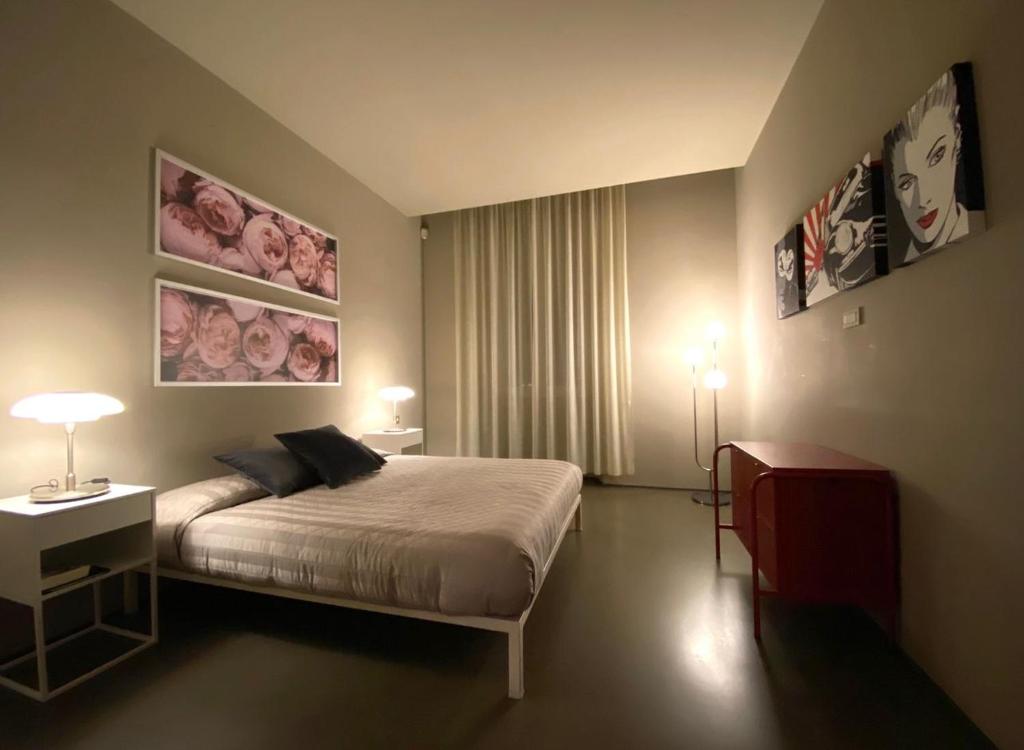 En eller flere senge i et værelse på Settala Quattro Terrace
