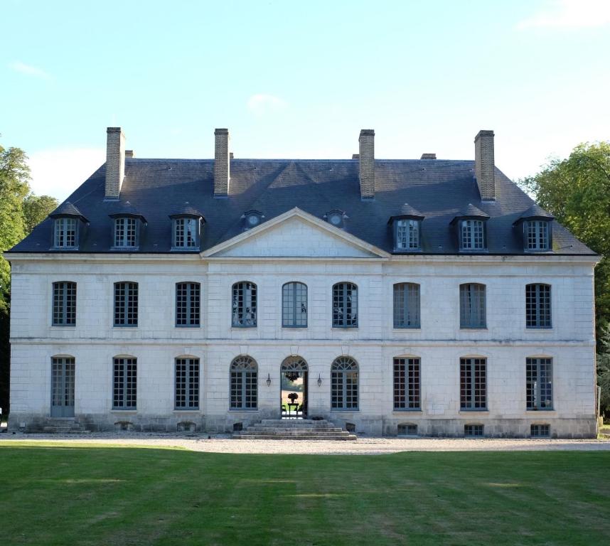 una gran casa blanca con un gran patio en Château de Trébons en Grainville-Ymauville