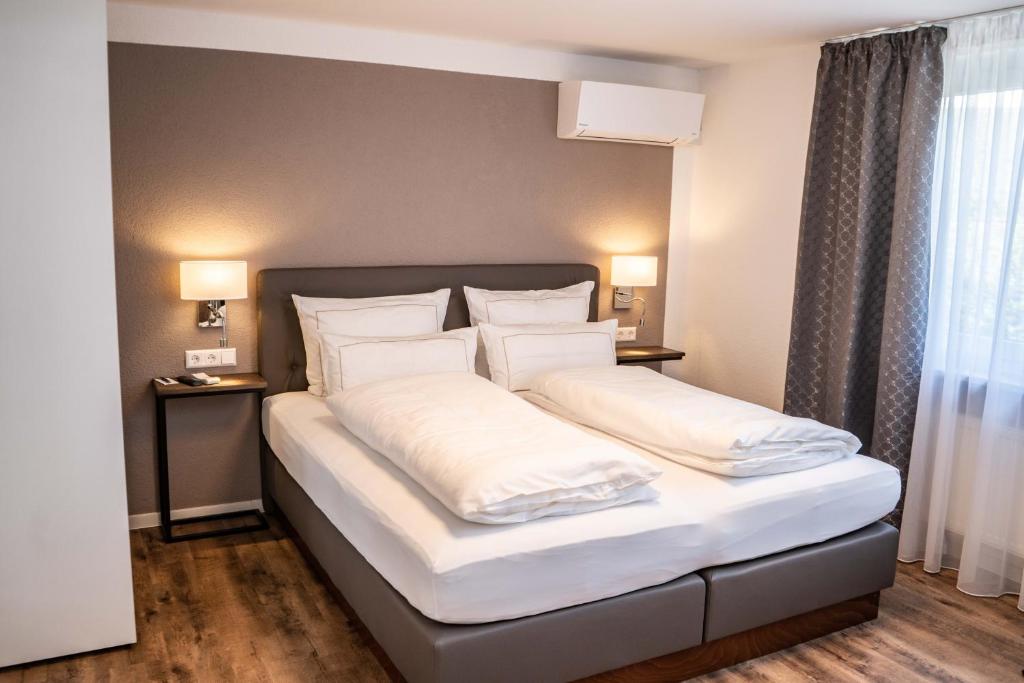 Postel nebo postele na pokoji v ubytování CityApartments Residence klimatisiert