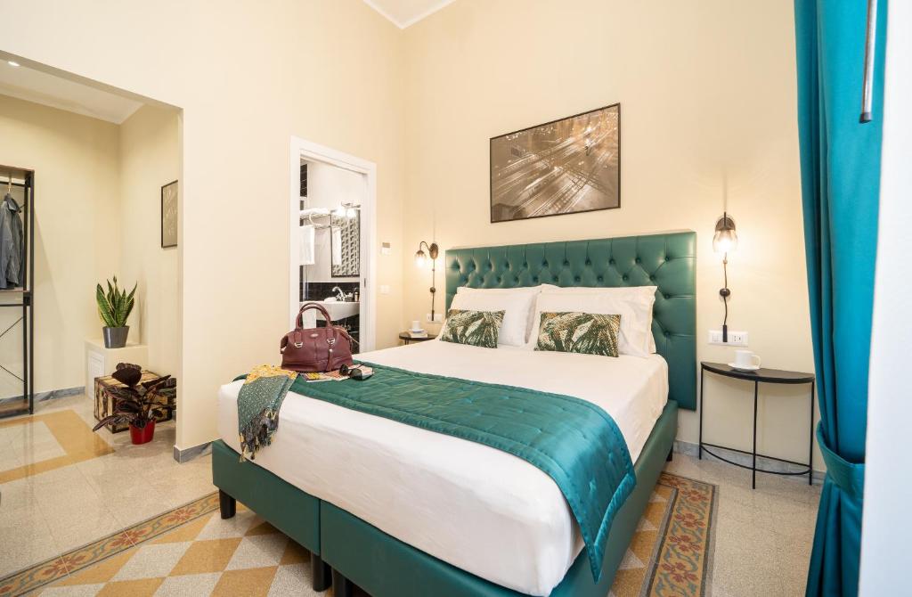 a bedroom with a large bed with a green headboard at Sweet Home Pigneto Guest House in Rome