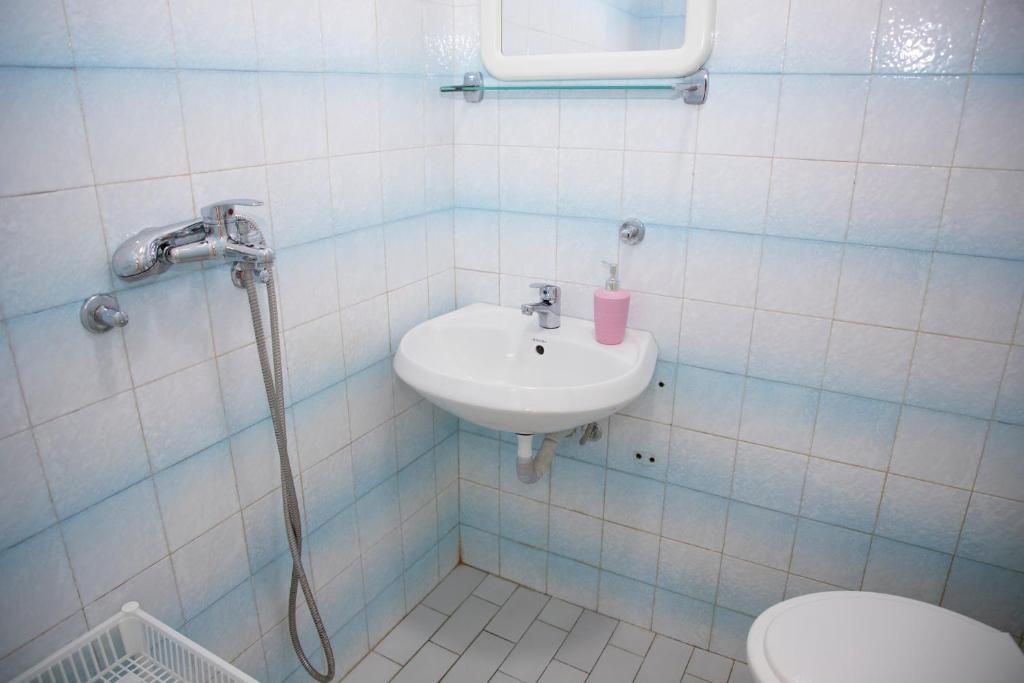 a bathroom with a sink and a toilet at 4 Studios Becic in Budva