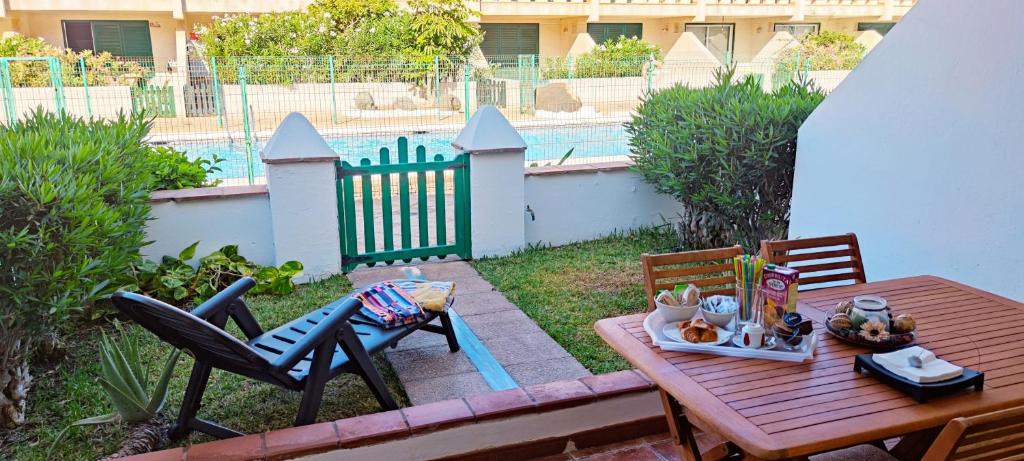 a table and chairs on a patio with a fence at Balancon Playa Cabezo in El Médano