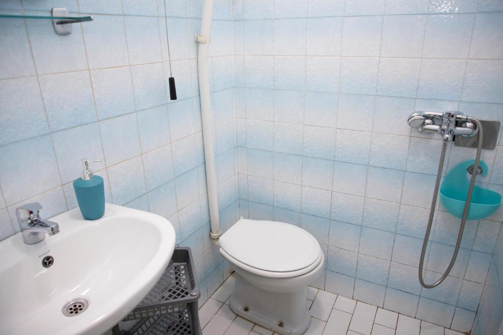 a bathroom with a toilet and a sink at 4 Studios Becic in Budva