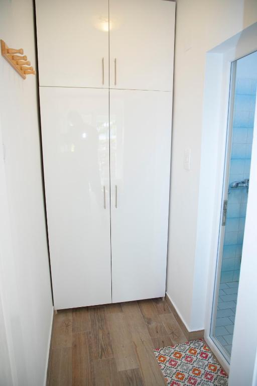 a room with white cabinets and a rug at 4 Studios Becic in Budva