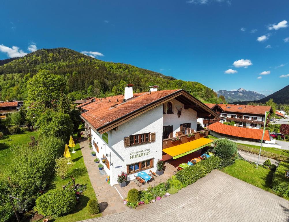 an aerial view of a house in the mountains at Hotel Hubertus Schliersee in Schliersee