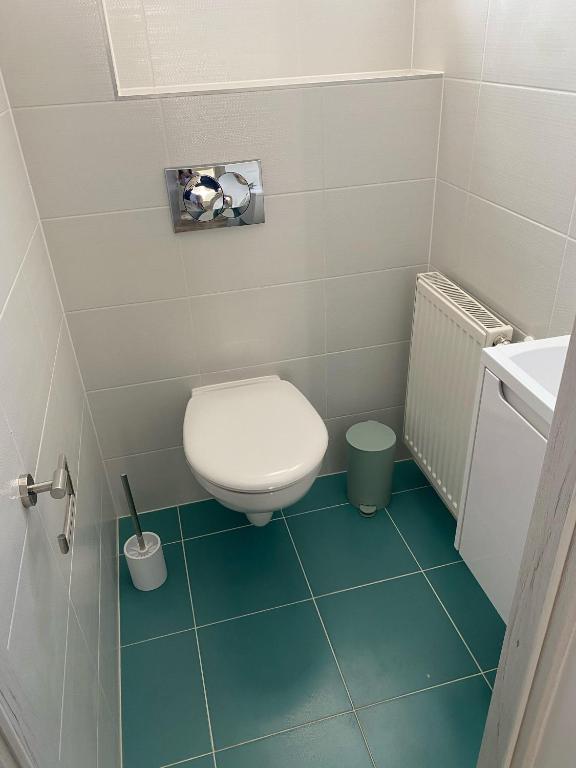 a small bathroom with a toilet and a sink at BB Vendégház in Villány