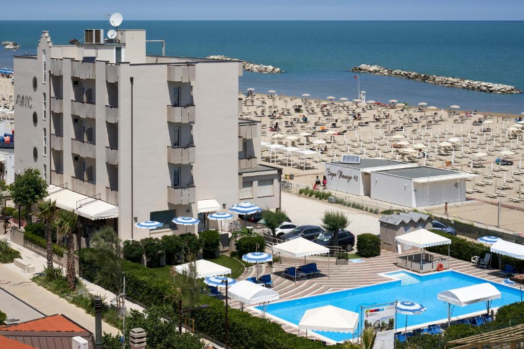 a view of a beach with a hotel and a resort at Hotel Atlantic in Rimini