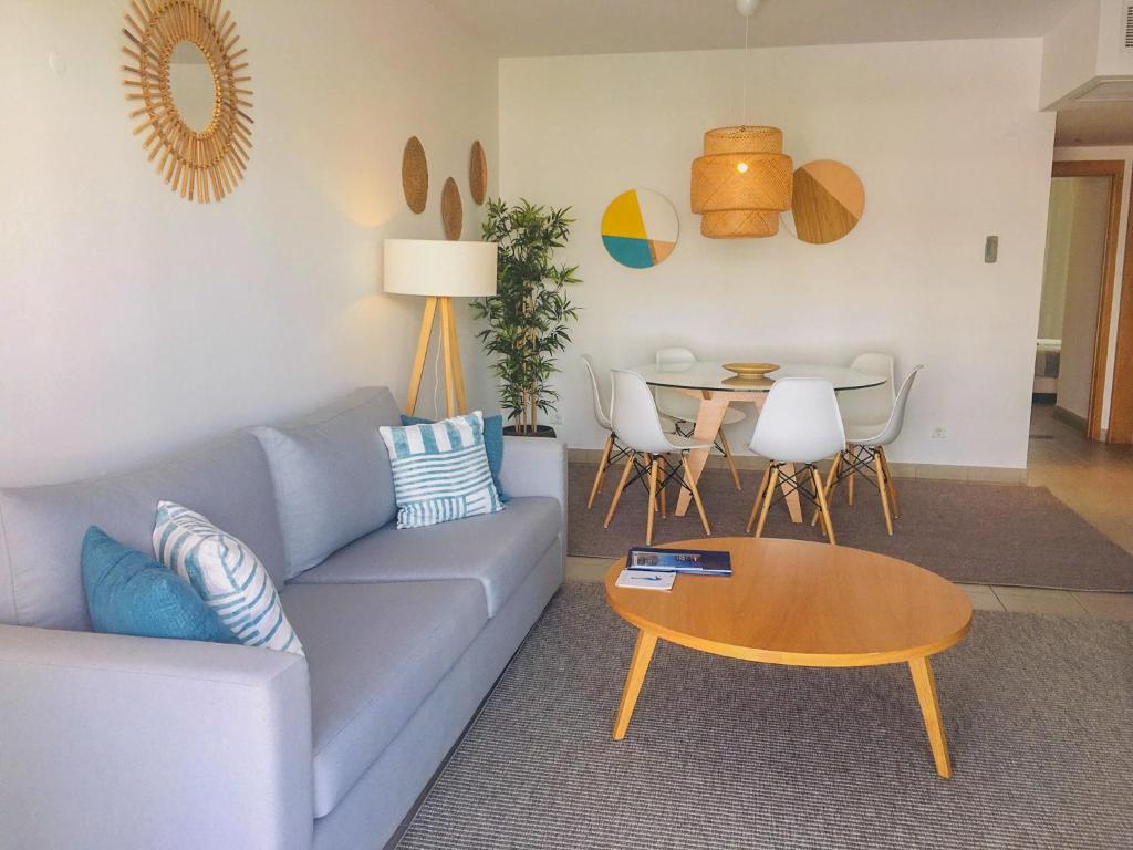 a living room with a blue couch and a table at Marina Club Lagos Resort in Lagos