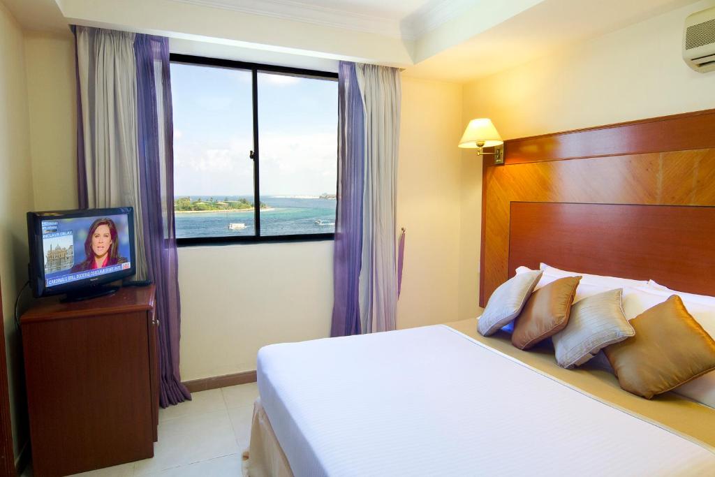 Кровать или кровати в номере Mookai Hotel