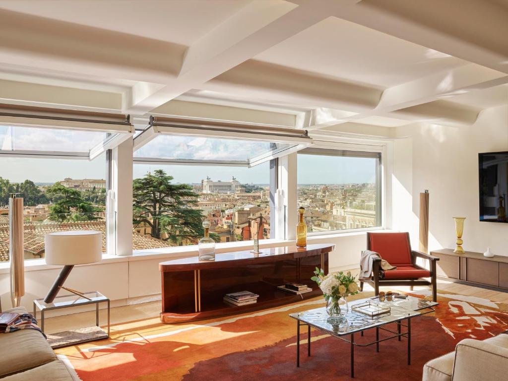 a living room with a view of the city at Hotel Eden - Dorchester Collection in Rome