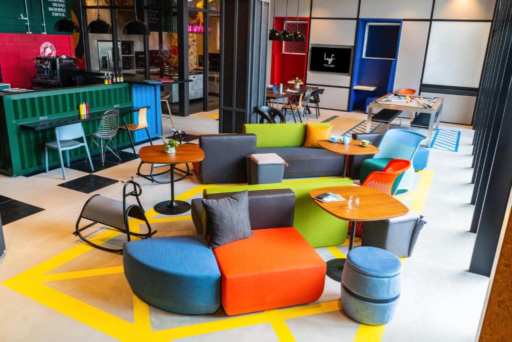 a restaurant with colorful chairs and tables in a store at lyf Tenjin Fukuoka in Fukuoka