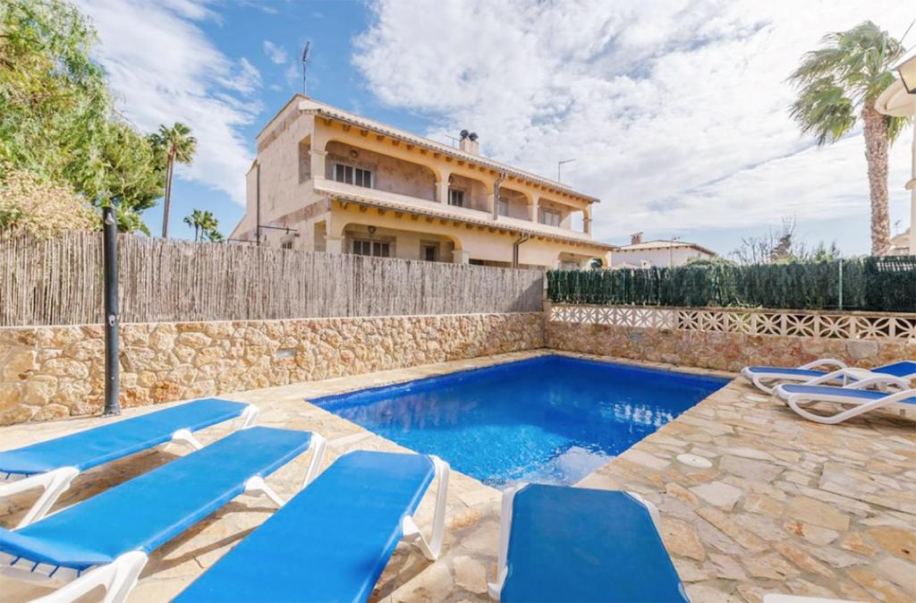 a villa with a swimming pool and a house at Benestar Pool and Beach in Platja de Muro in Muro