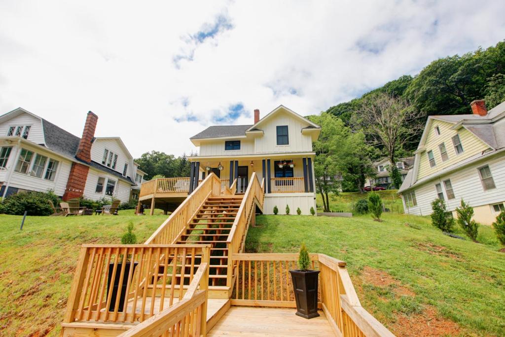 a house with a wooden staircase leading up to a house at Josephine Cottage in Hot Springs
