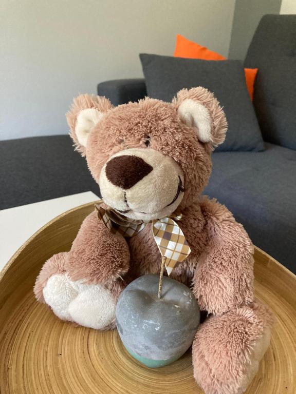 a teddy bear sitting on a wooden table at VP APARTMENTS in Sillamäe