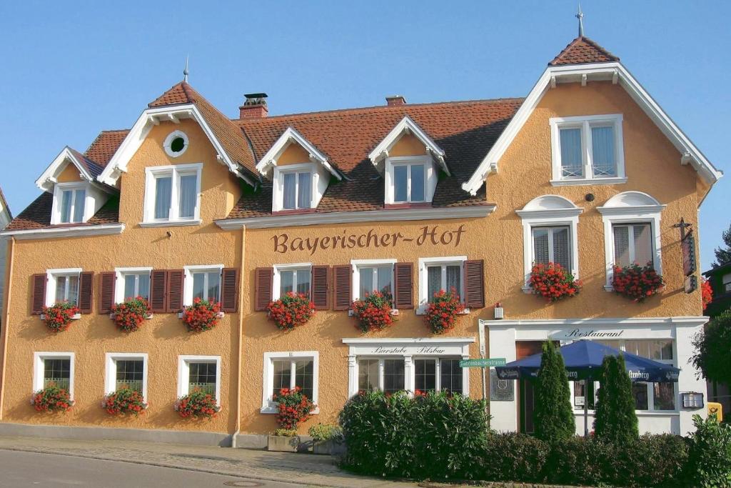 a large yellow building with flowers on the front at Bayerischer Hof in Heiligenberg