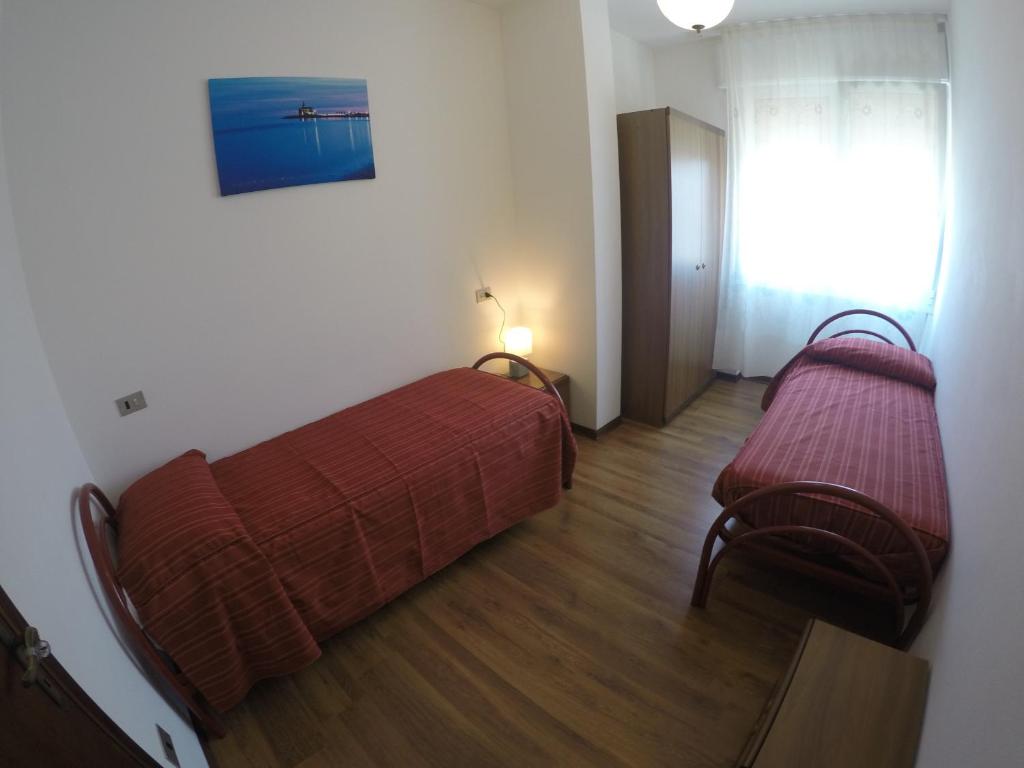 Postel nebo postele na pokoji v ubytování Residence Caorle Apartments - Agenzia Cocal