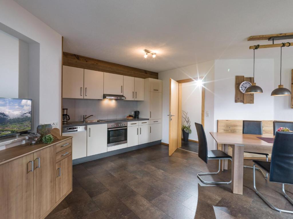 a kitchen with a table and a dining room at Ferienwohnung Eberharter in Hart im Zillertal