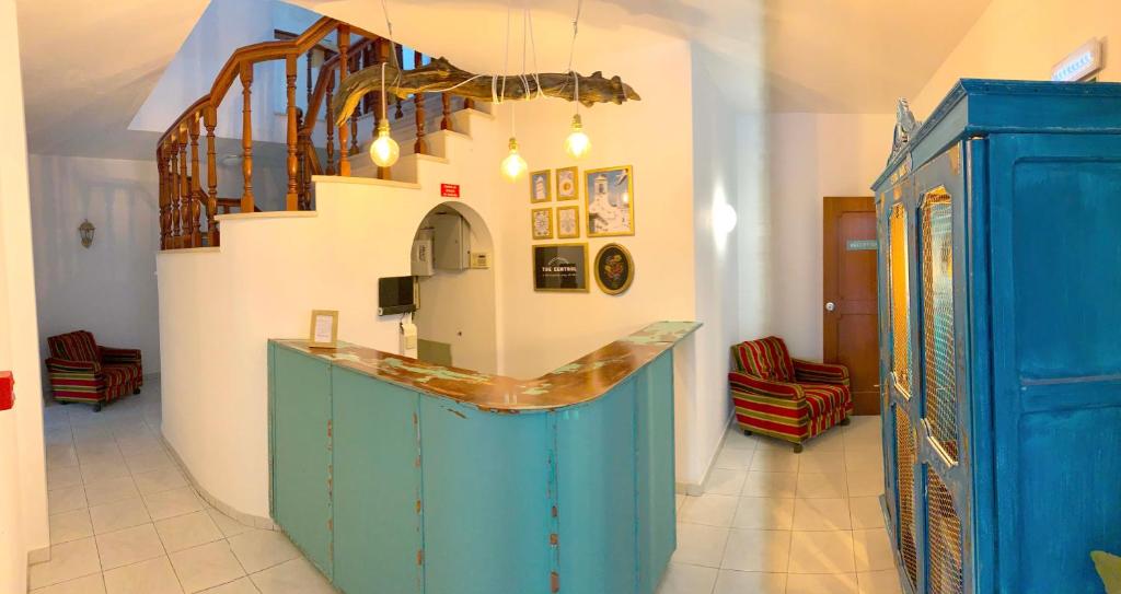 a room with a blue cabinet and a staircase at The Central Guesthouse in Faro