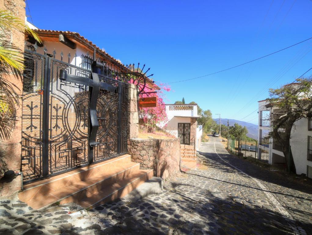 a street in a town with a cross on a gate at Casa de las Cruces Taxco in Taxco de Alarcón