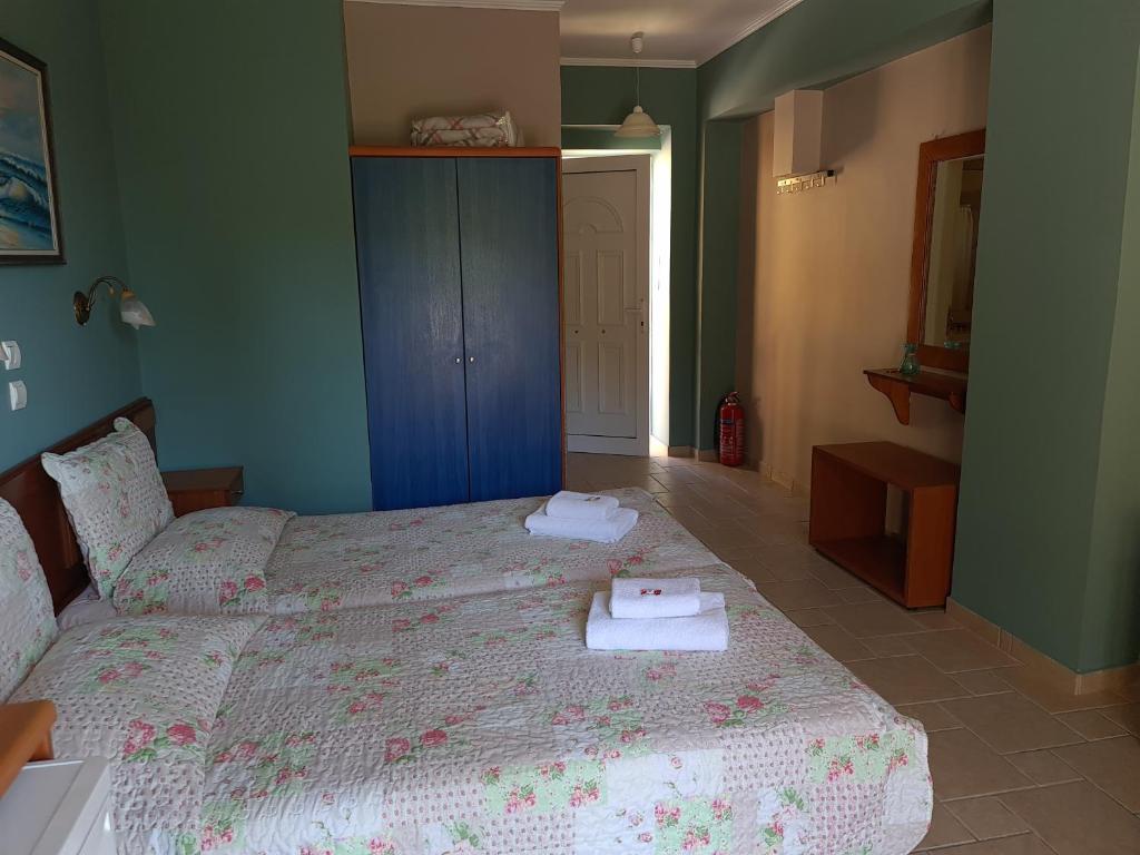 a bedroom with a bed with two towels on it at Edem Studios in Syvota