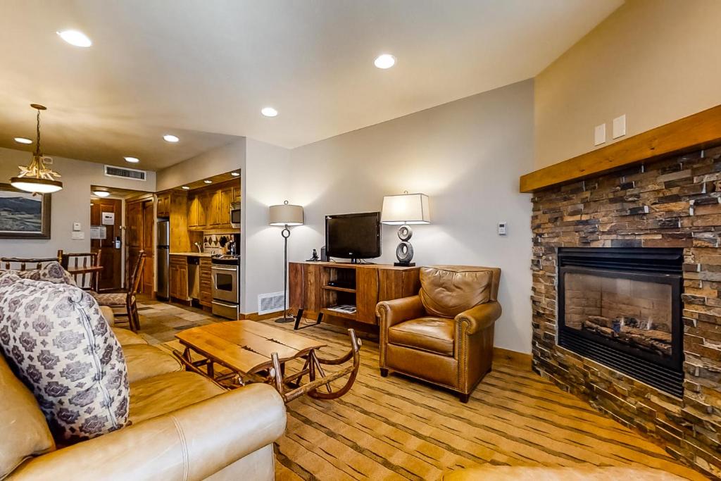 a living room with a couch and a fireplace at Steamboat Resort Villas 608 in Steamboat Springs