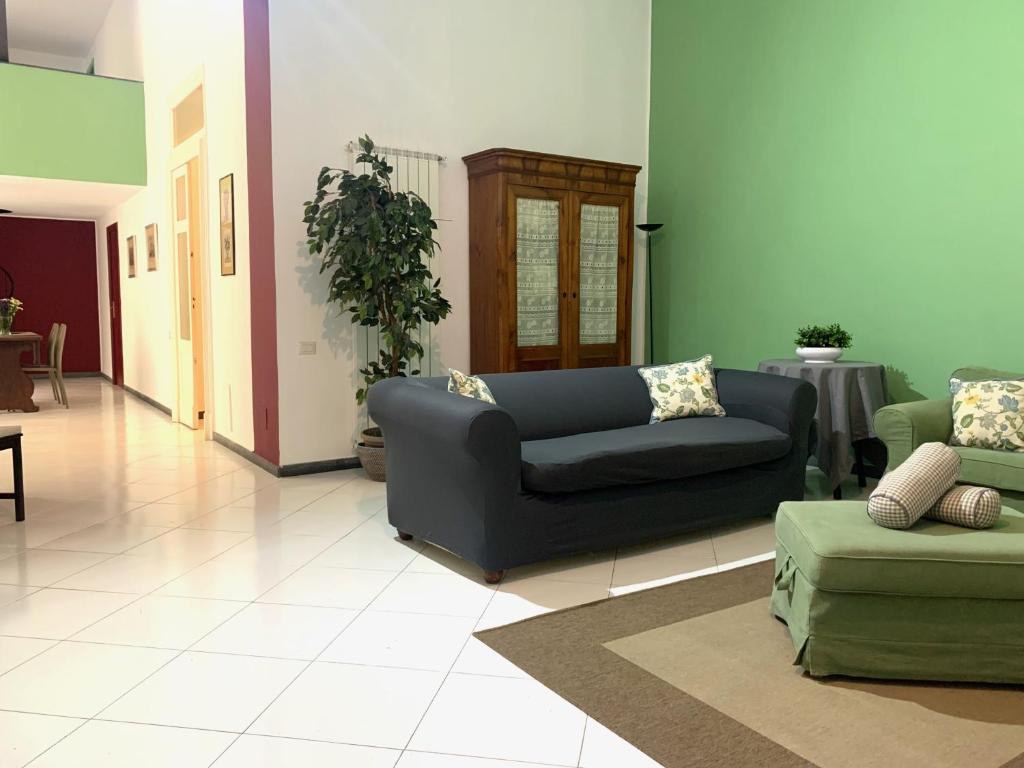 a living room with a couch and a chair at Casa del Plebiscito in Naples