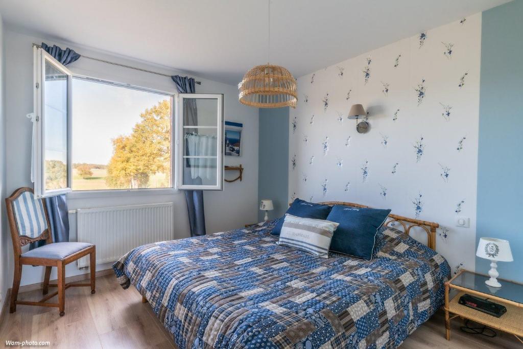 a bedroom with a bed and a window at Chambre d'hôtes de la Fontagrille in Épineuil-le-Fleuriel