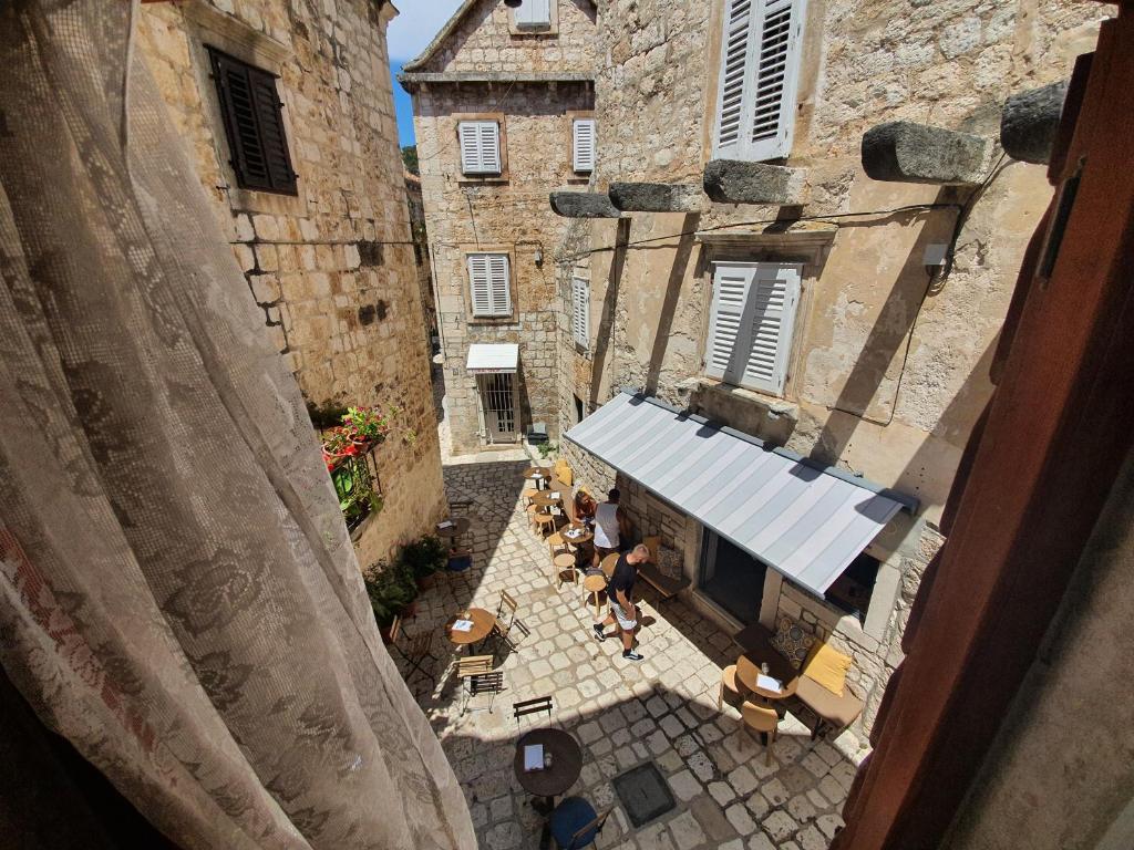 an overhead view of an alley with tables and chairs at Old Town Hvar Apartment in Hvar