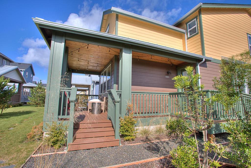 a house with a front porch with a staircase at Just Beachy in Ocean Shores
