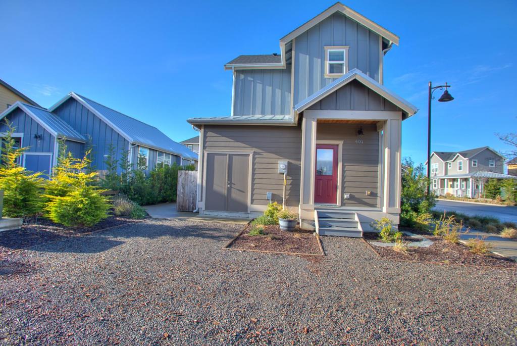 a house with a gravel driveway in front of it at Our Beach Adventure in Ocean Shores