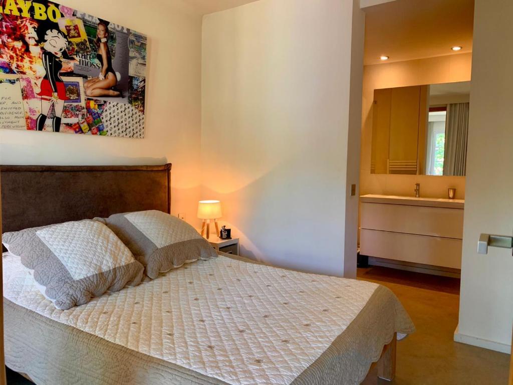 a bedroom with a bed and a large mirror at St Tropez T2 central in Saint-Tropez