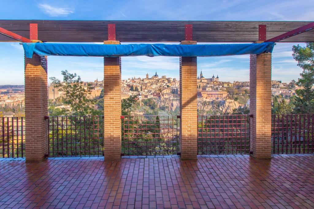 a gate with a view of a city at Cigarral Valdecolomba in Toledo