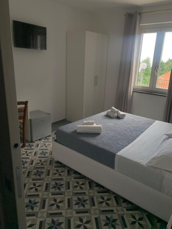 Łóżko lub łóżka w pokoju w obiekcie Il covo degli Dei