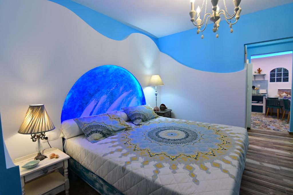 a bedroom with a bed with a blue ceiling at Alisaxni Studios in Argassi